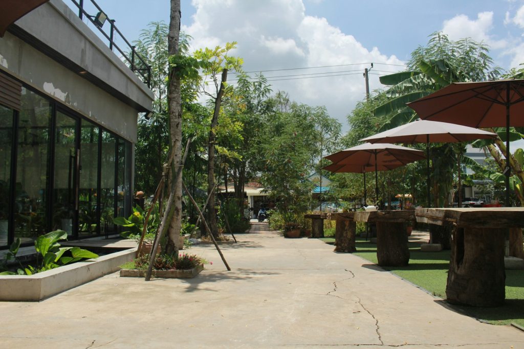 a building with trees and umbrellas