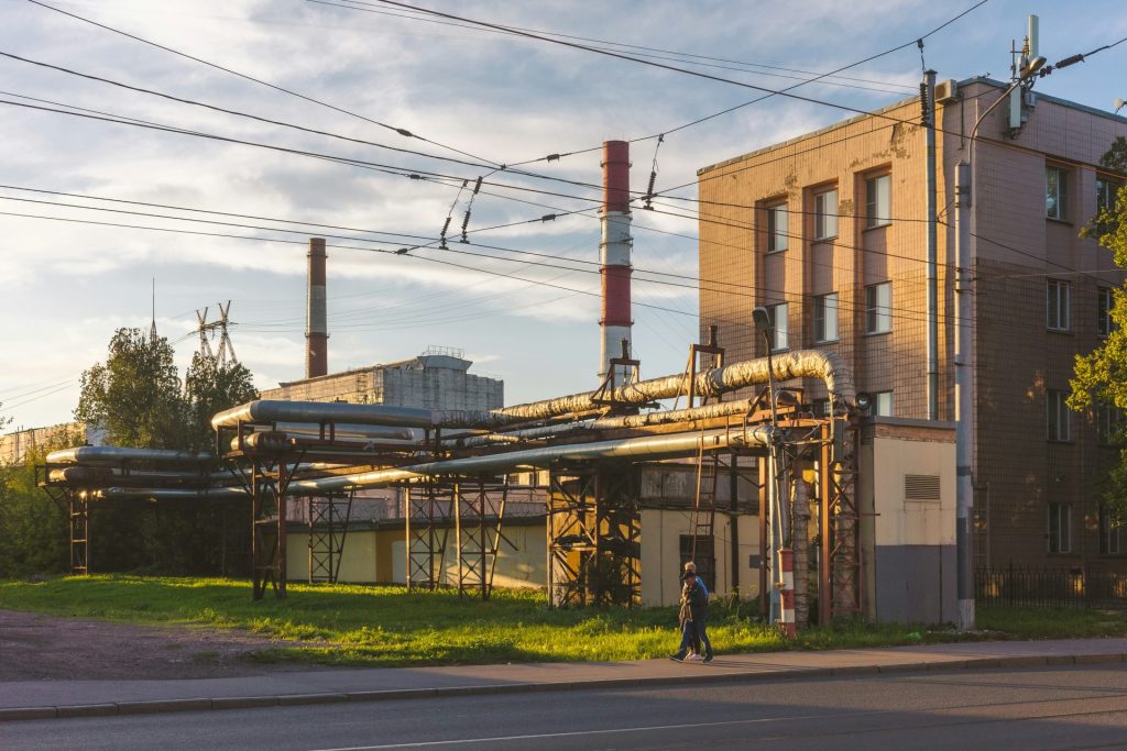 a man walking down a street next to a tall building